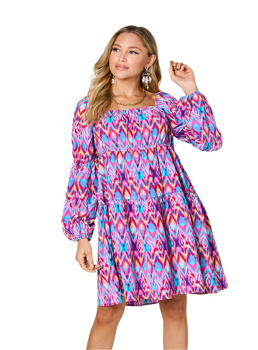 Hot pink ikat print mini dress with ruched bodice and square neckline.
