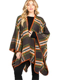 Woman wearing green plaid wrap shawl with orange trim over black top.
