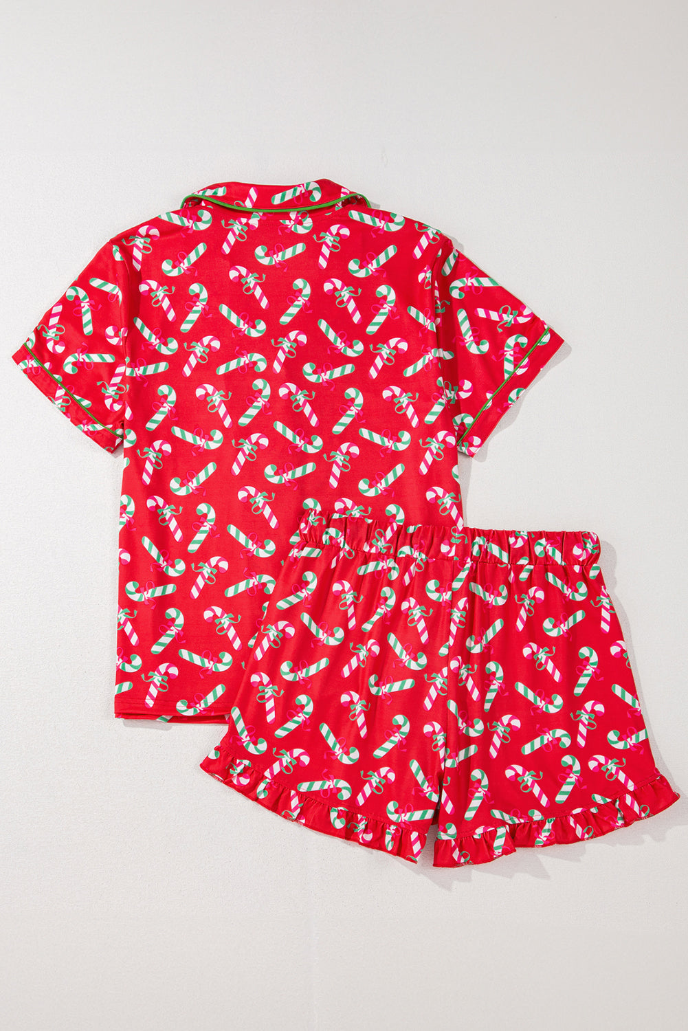 Short-sleeve button-up candy cane pajama set, ideal for a cozy night in during the holiday season.
