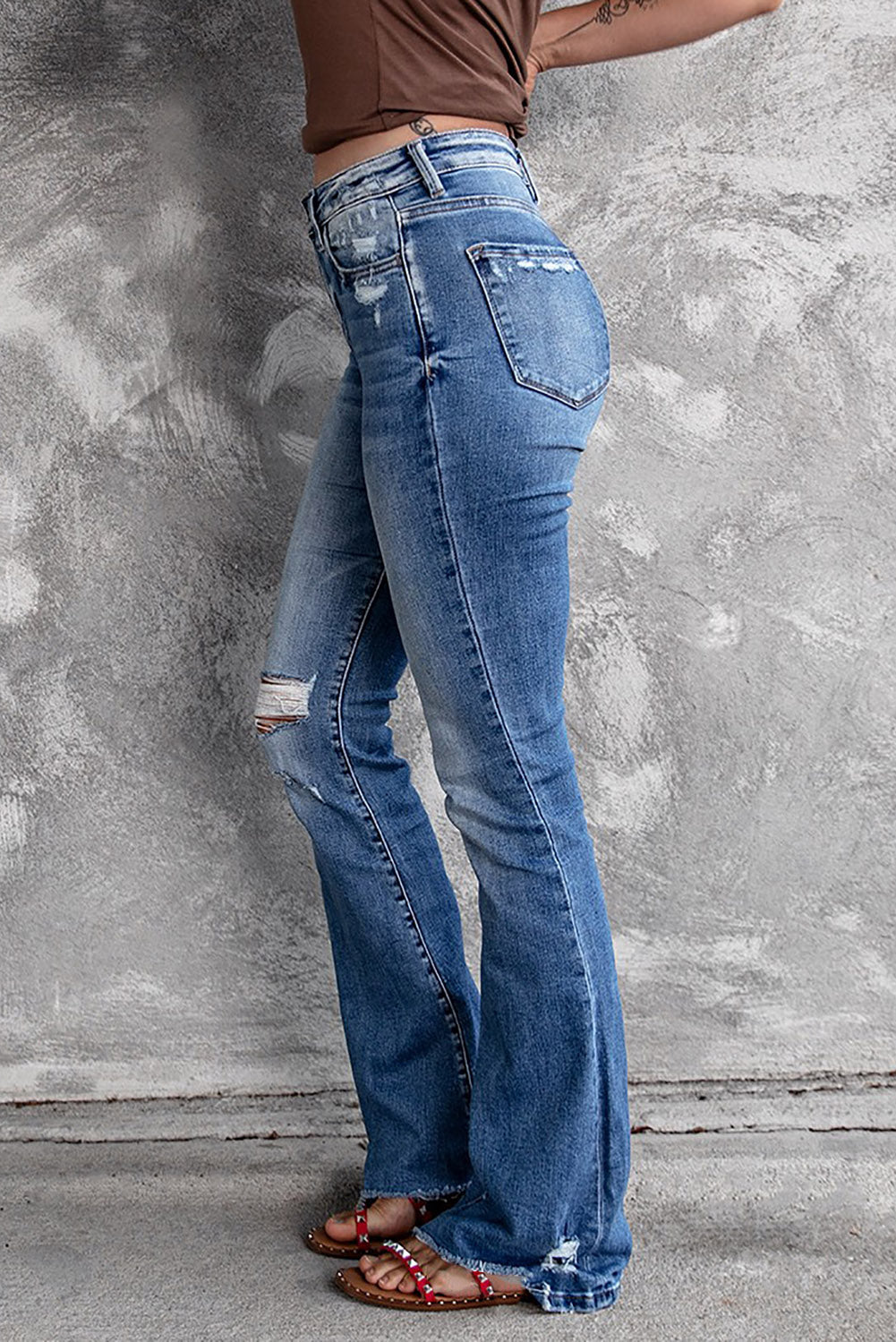 High waist flare jeans with ripped and raw hem details side view