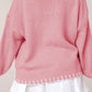 Side view of a pink bow-knot knit sweater, perfect for staying cozy and stylish during winter.

