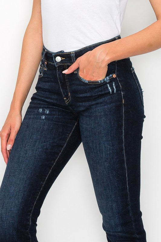 Side view of plus-size dark wash high-rise skinny straight jeans.