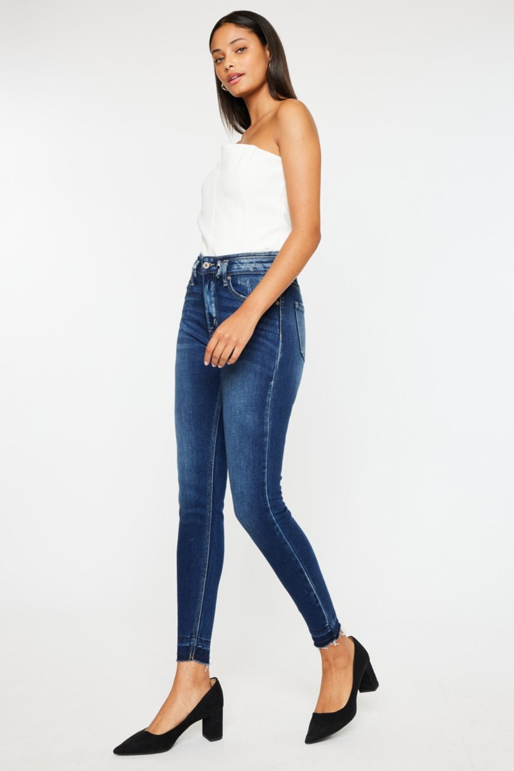 Side view of Kancan ankle skinny jeans showcasing the raw hem detail.
