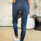 Women’s mid-waist jeans with subtle ripped details.
