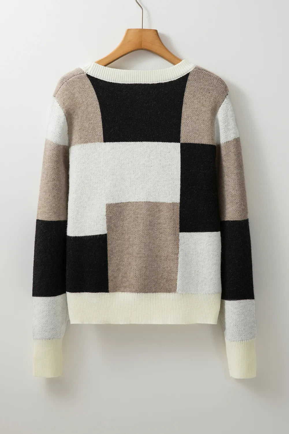 Modern neutral color block knit sweater, perfect for fall and winter wear.
