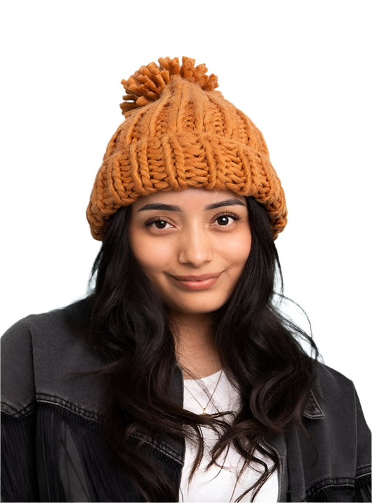 Soft chunky cable knit beanie in brown, perfect for staying warm and stylish in winter
