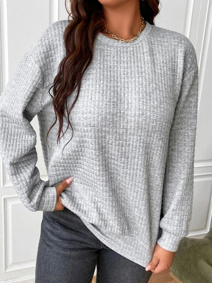 Waffle-knit sweatshirt for women available in gray and black, casual style.
