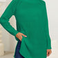 Green winter pullover with a turtleneck and slit details.
