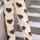 Women’s winter onesie with oversized heart print and hood