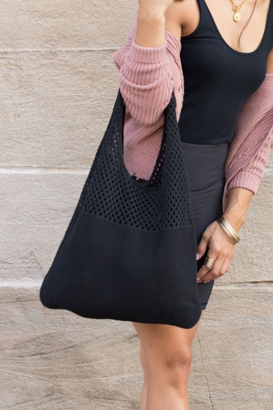 Minimalist black knit hobo bag, perfect for casual outings.
