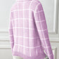 Close-up of soft pink plaid knit turtleneck with ribbed cuffs