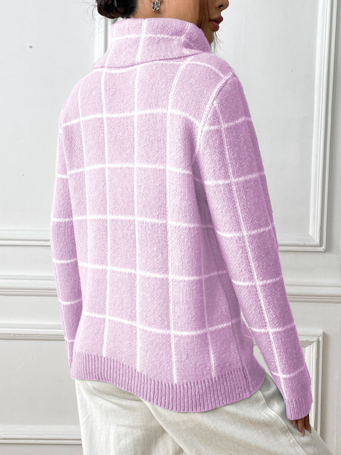 Close-up of soft pink plaid knit turtleneck with ribbed cuffs