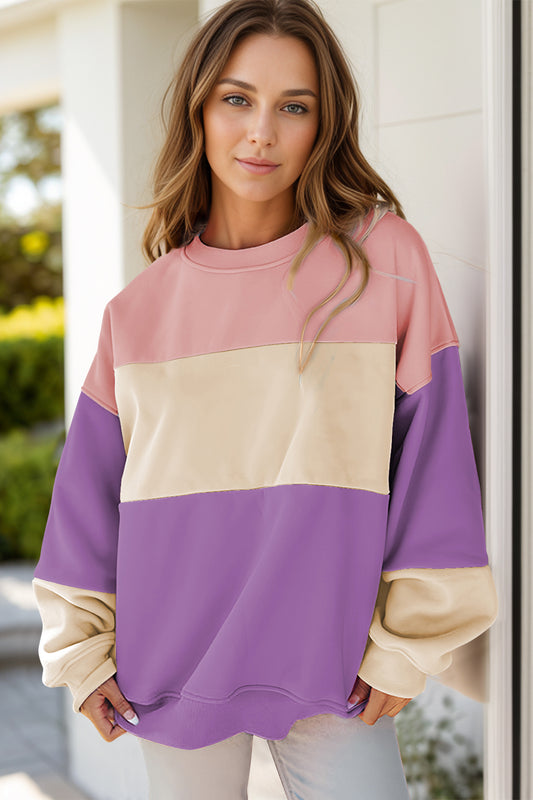 Front view of pink, cream, and purple color block sweatshirt in an oversized fit