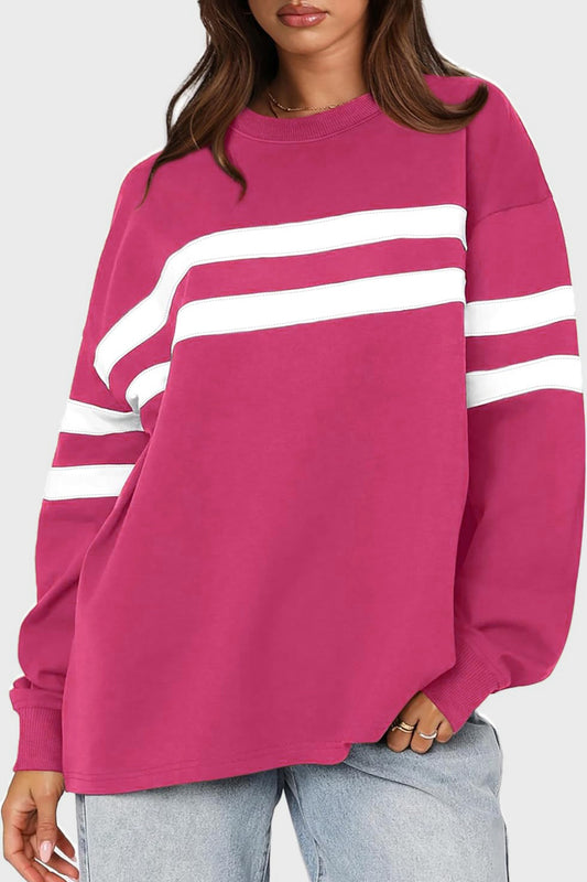 Soft pink oversized sweatshirt with white stripes, front view.
