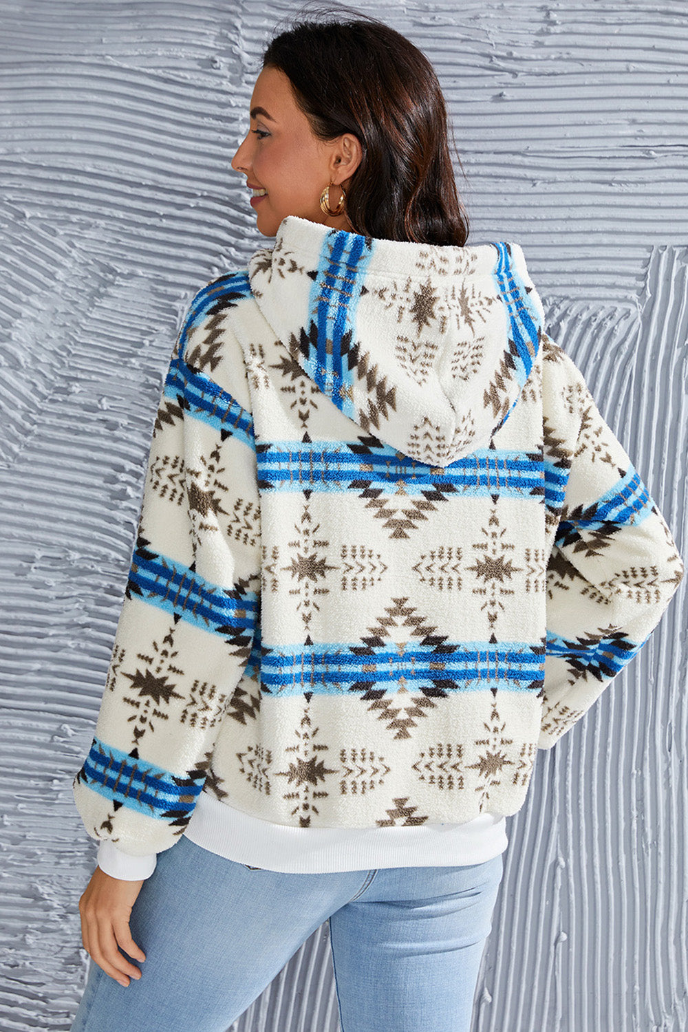 Women's fleece hoodie featuring a geometric print and a half-zip for easy layering.