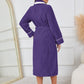 Purple lounge robe with pockets and luxurious plush fabric.
