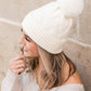 Chic white chunky knit winter beanie with plush faux fur pom top