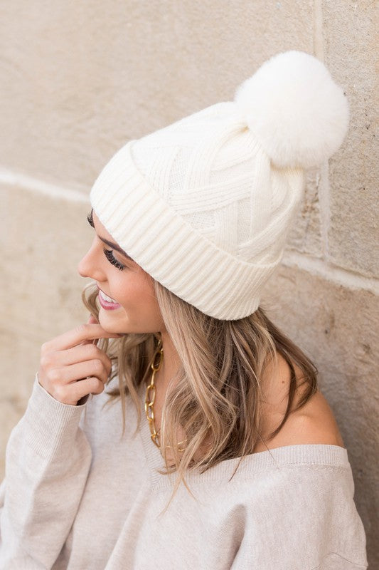 Chic white chunky knit winter beanie with plush faux fur pom top