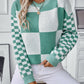 Modern turquoise sweater featuring a unique mix of checkerboard and color-block designs.
