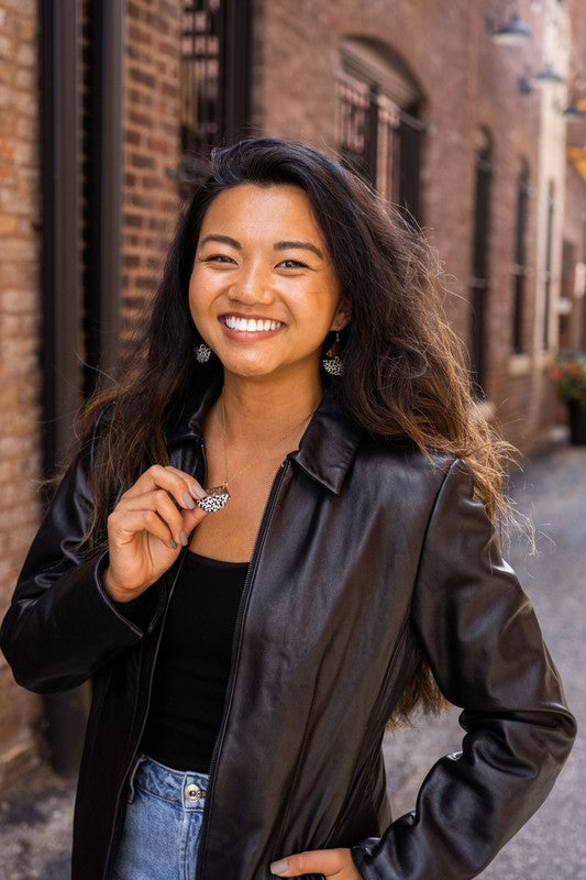 Ava Black Dot Necklace featuring a triangle and black speckled half-circle.