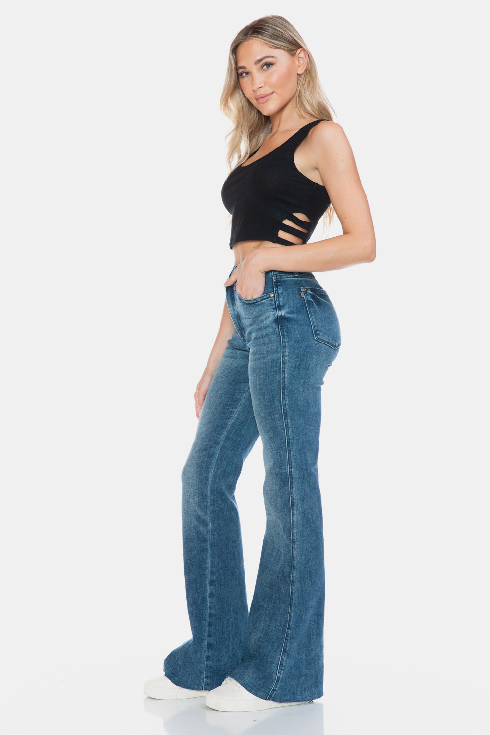 Vintage wash flare jeans featuring a modern cut hem detail.
