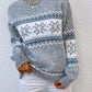 Stylish cloudy blue sweater with snowflake detailing and ribbed edges, great for layering in winter.

