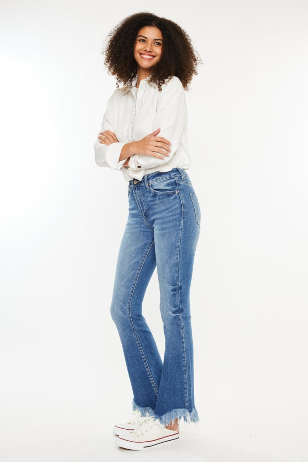 Stylish high-rise Kancan jeans showcasing the frayed hem design.
