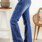 Women's straight-leg jeans in medium wash with raw hem and distressing.
