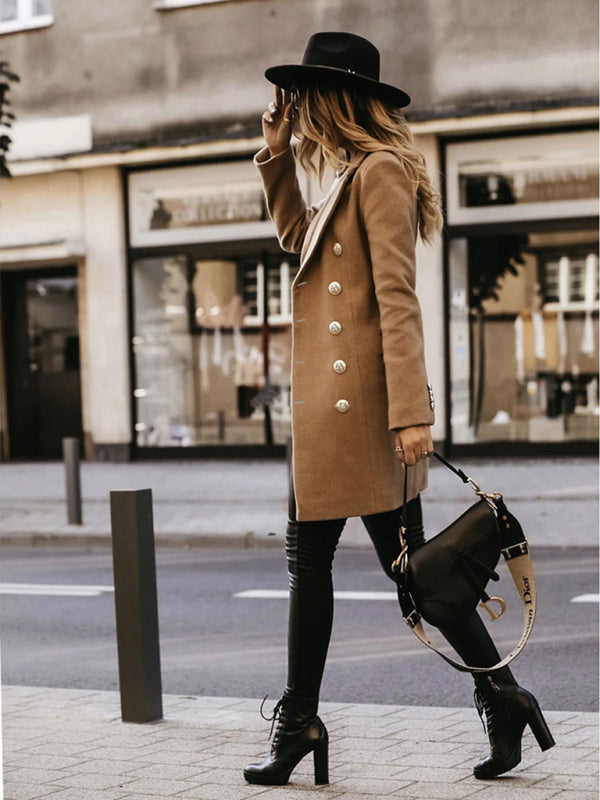 Side view of a khaki double-breasted coat with a classic H-line silhouette.
