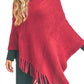 Burgundy fringed poncho paired with black jeans, featuring a textured knit design for a chic and comfortable style.