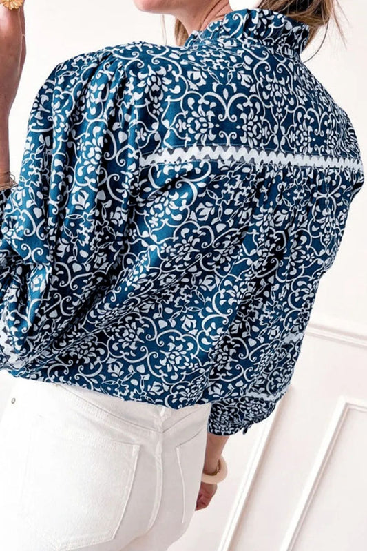 Elegant blue and white patterned mock neck blouse styled for everyday wear
