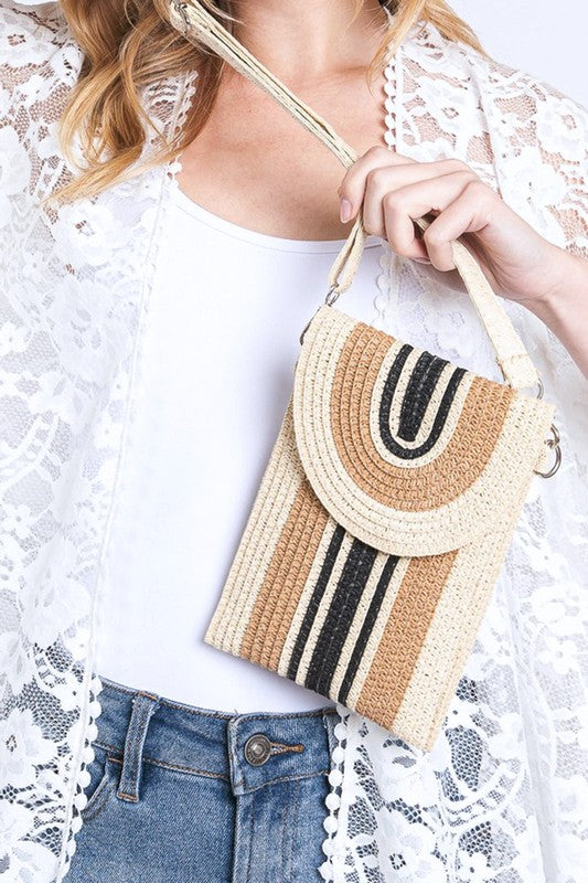 Compact straw phone bag featuring adjustable crossbody strap.
