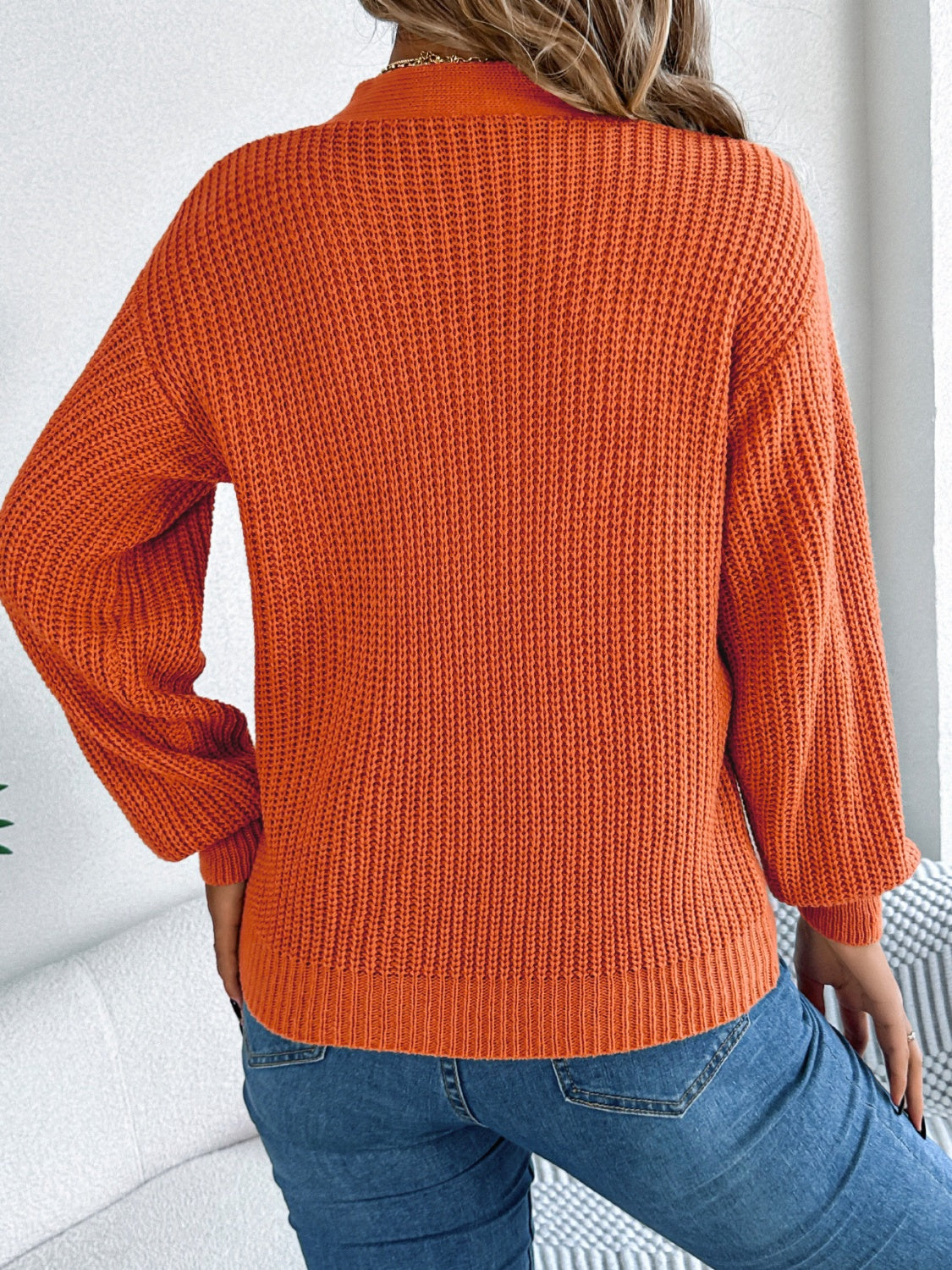 Orange cable knit sweater with trendy V-neck cutout design