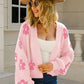 Women’s knit cardigan in pink with white floral patterns
