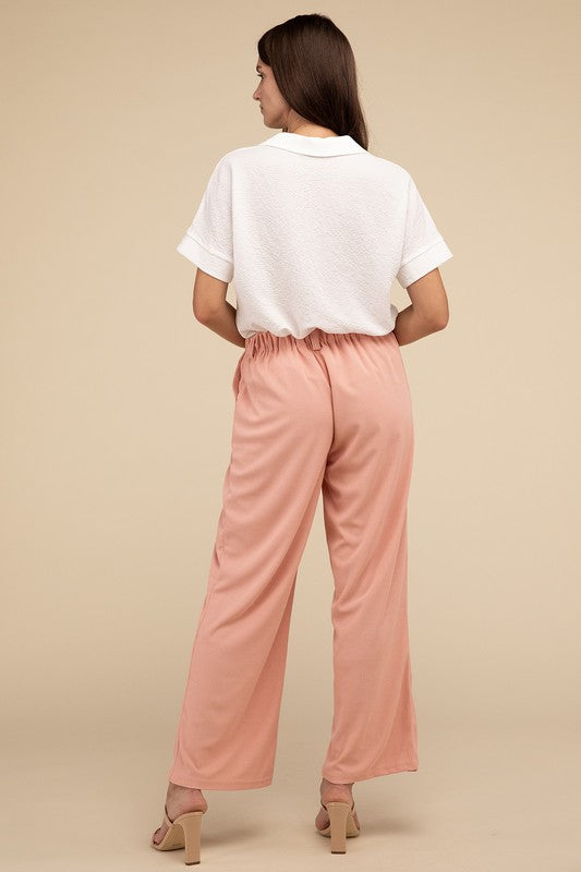 Tailored pink waffle pants with relaxed silhouette
