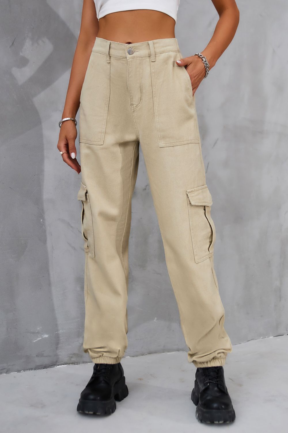 Tan buttoned high-waist cargo pants shown in a front view.
