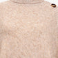 Women’s tan ribbed knit poncho with cozy turtleneck.
