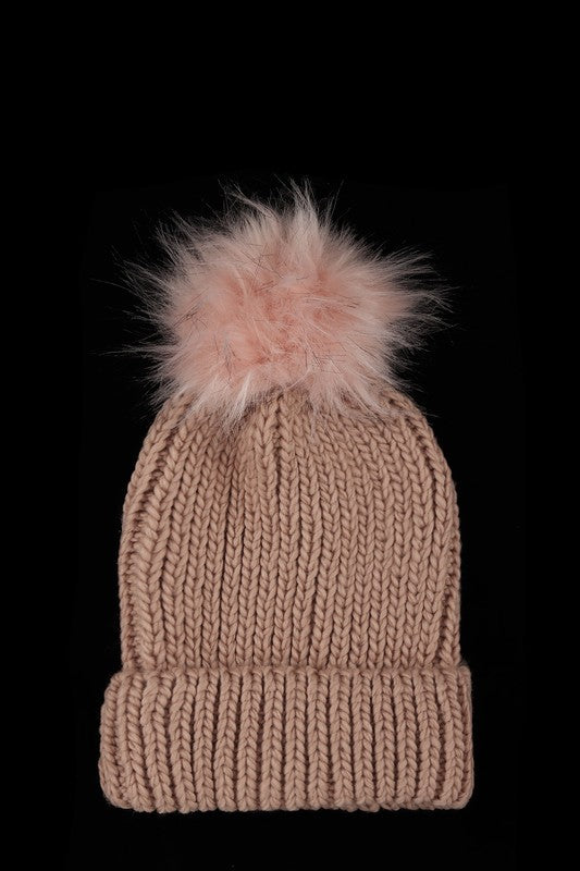 Blush knit cuffed winter hat with playful pom-pom detail.
