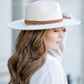 Trendy cream Panama hat with a wide brim and tassel belt embellishment.
