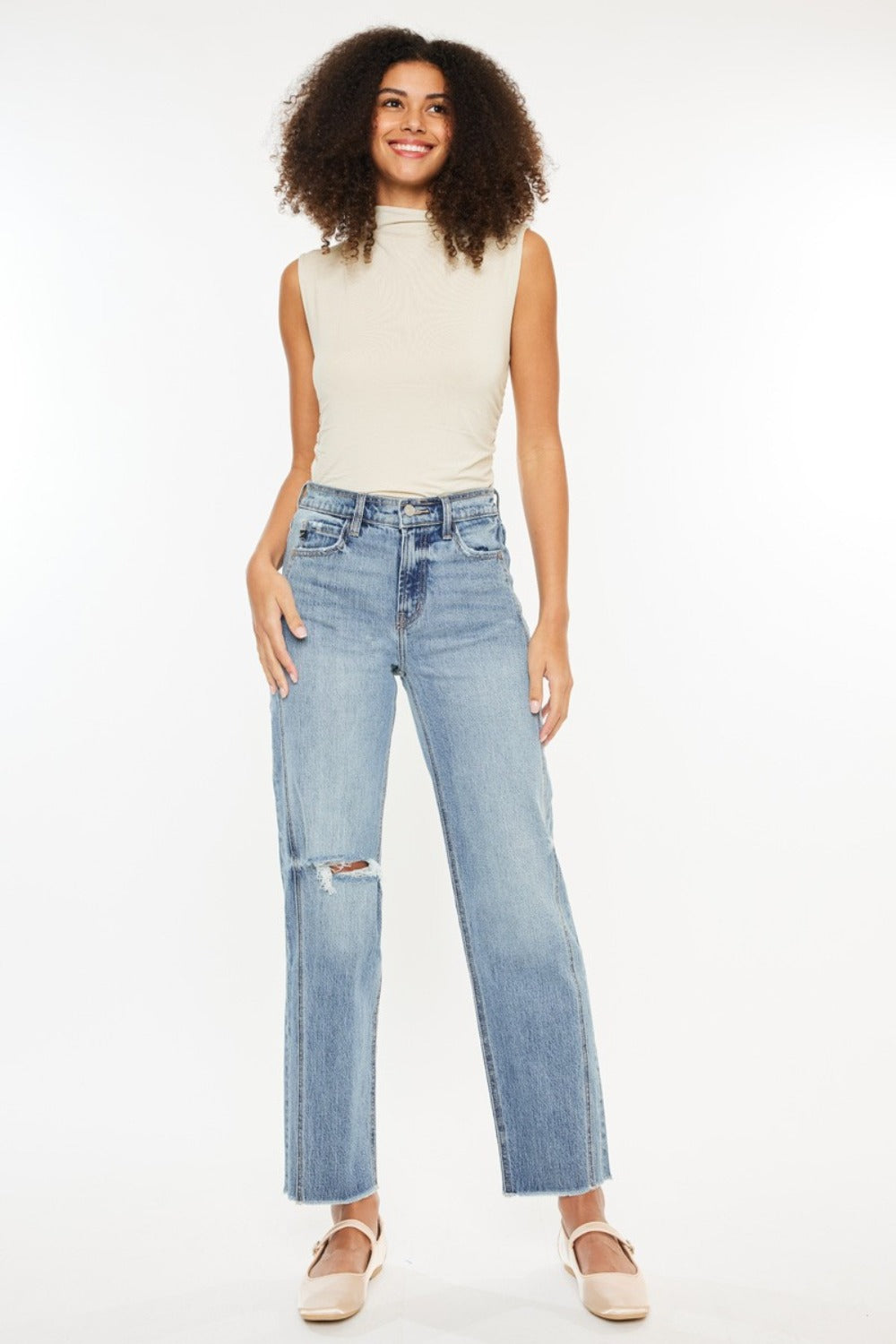 Trendy women’s jeans with a high rise, distressed detailing, and raw hem by Kancan.
