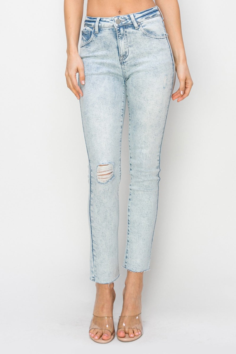 Light-wash high-rise skinny jeans with subtle distressed details on the thigh
