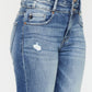 Close-up of distressed flare jeans by Kancan with a wide waistband for added comfort.
