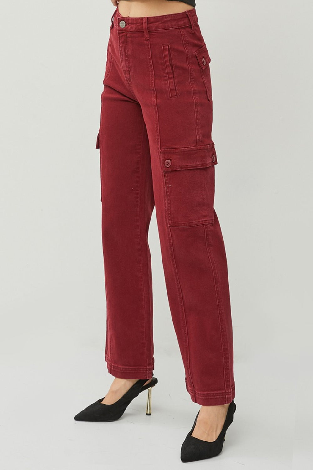 Full-length photo of wide leg cargo jeans in red, showcasing functional pockets and a relaxed fit.
