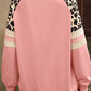 Relaxed-fit sweatshirt in pink with leopard print and striped sleeves for a chic casual look.
