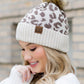 Brown CC leopard print pom hat, combining cozy warmth with bold style
