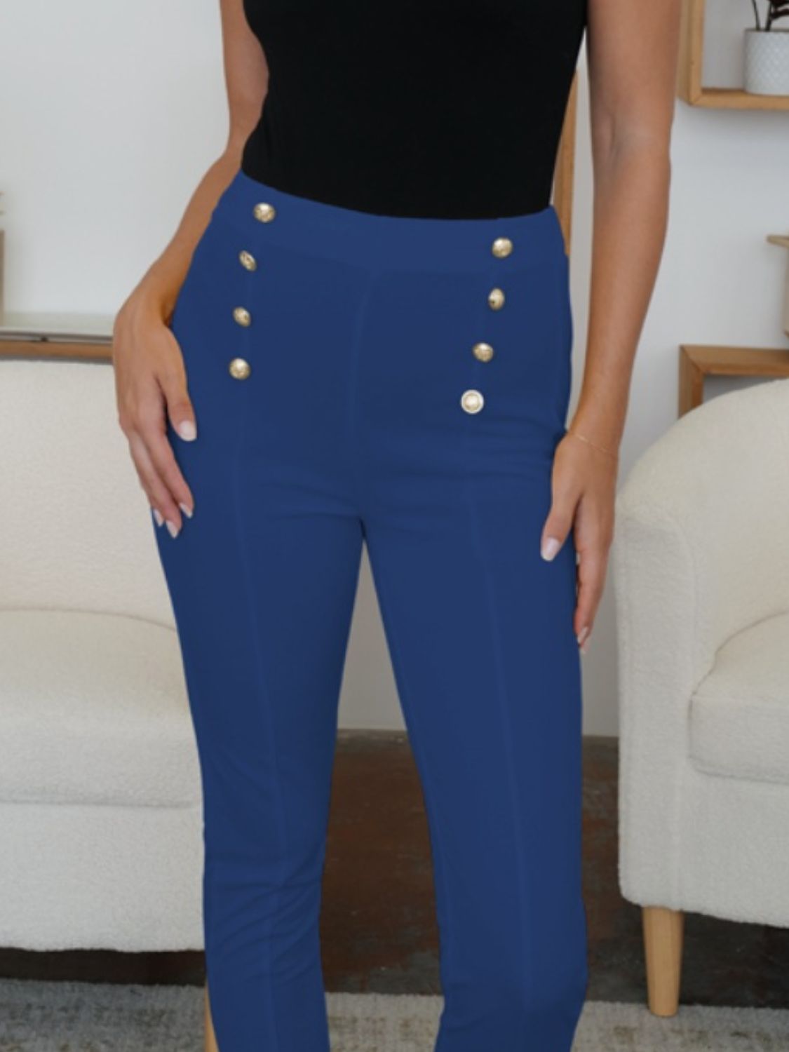 Stylish navy skinny pants featuring button accents on the front.