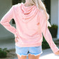 Stylish pink cow print pullover paired with denim shorts
