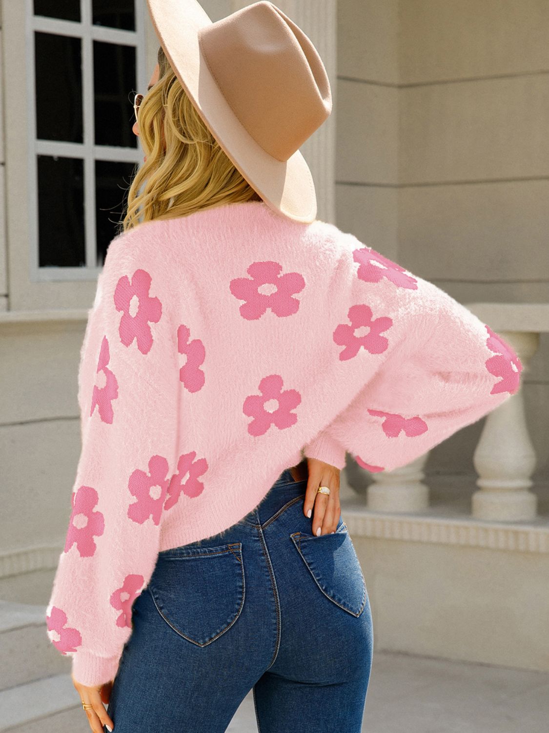 Women’s pink cardigan with white floral detailing
