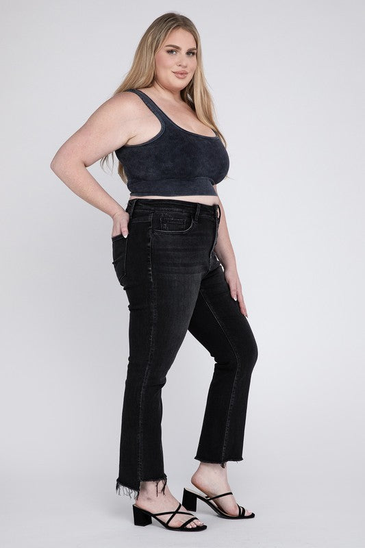 Edgy frayed hem on black plus-size crop flare jeans with cropped length.
