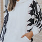 Close-up of the printed sleeves on a trendy casual hoodie with dropped shoulders.
